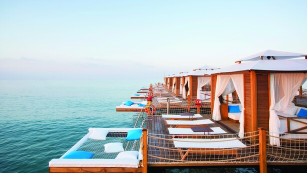 An overwater bungalows with private balconies, wooden railings, and white canopies. - Regnum Carya - All Inclusive (Serik)