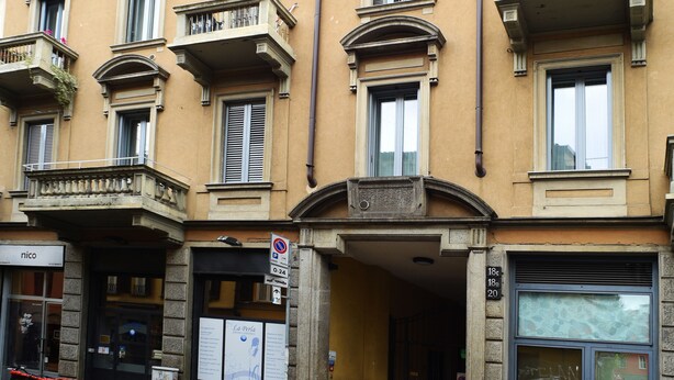 A multi-story building with balconies, a storefront, and a bicycle parked outside. - B&B Sant'Agostino (Milan)