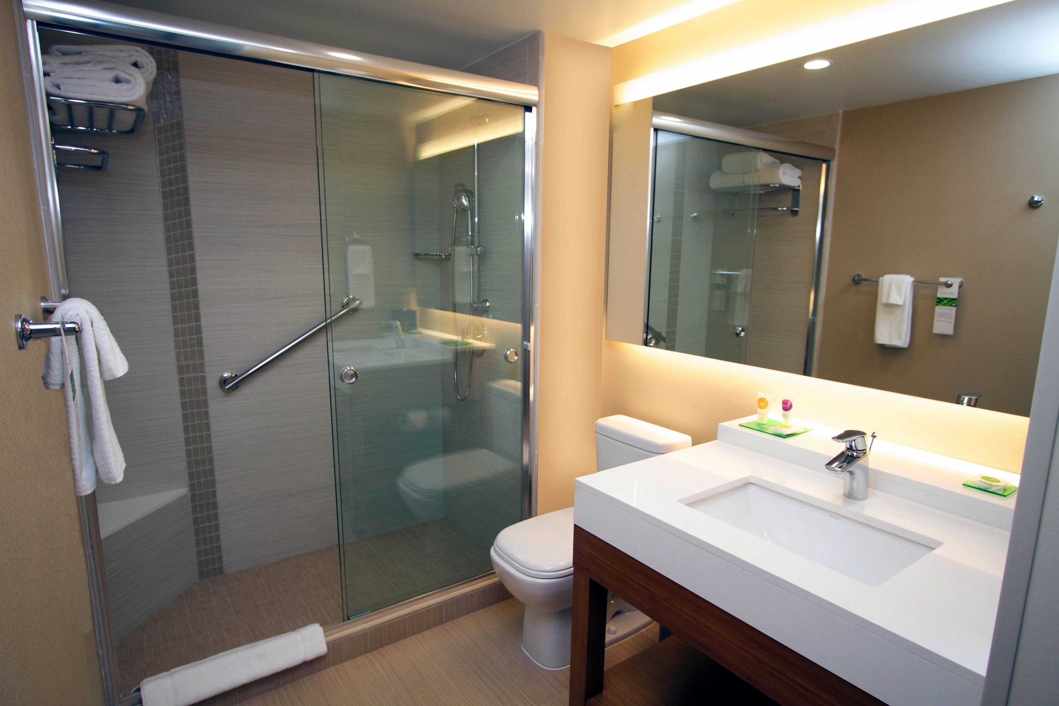 combined shower/bathtub, designer toiletries, hair dryer, towels