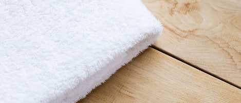A white towel on a wooden surface.