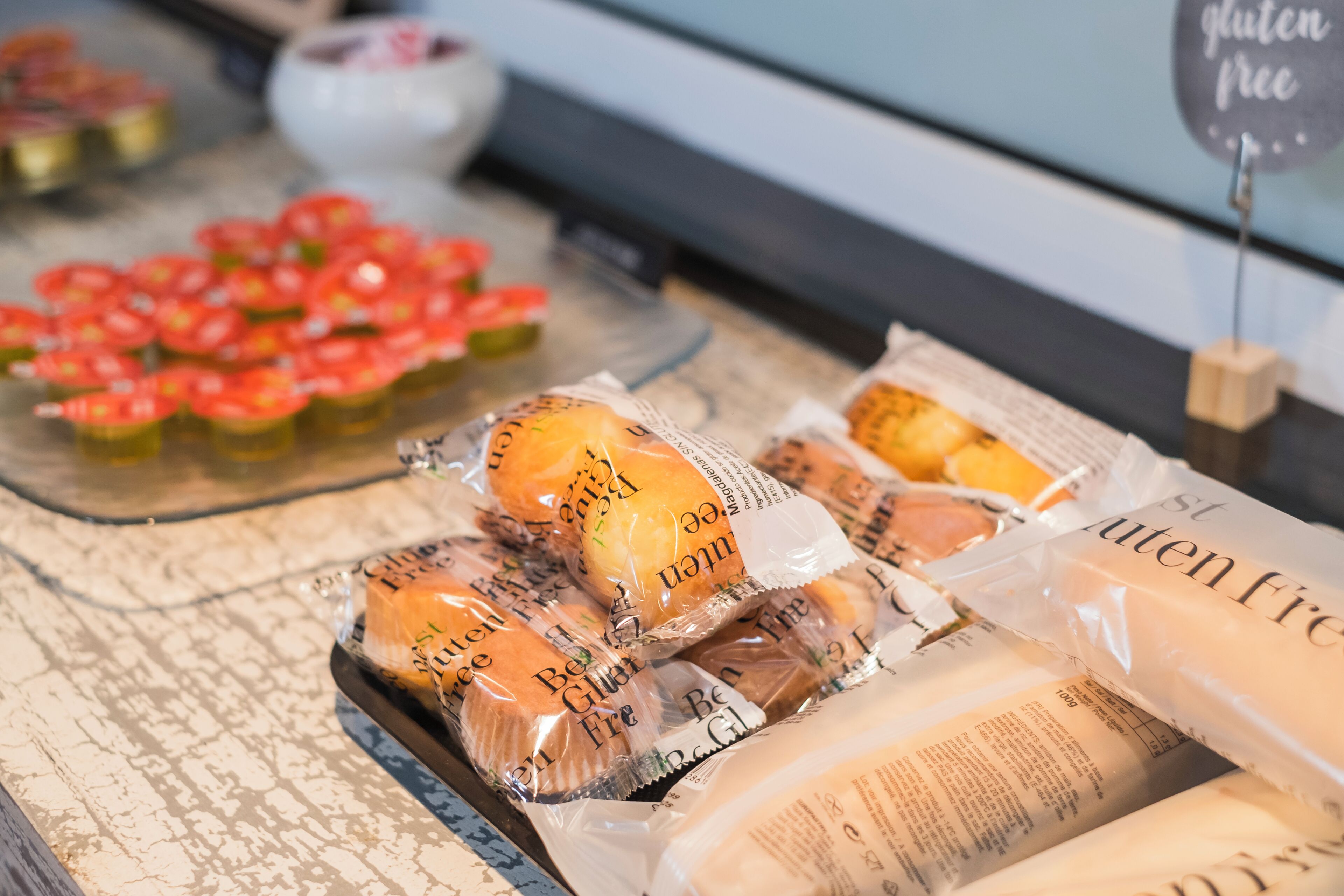 A display of gluten-free baked goods in a bakery setting.