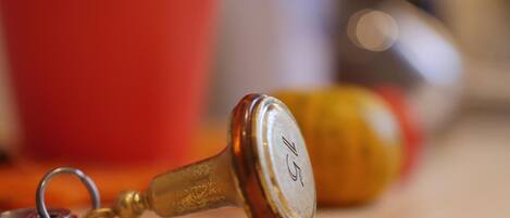 A close-up of a vintage keychain with a metal ring and a wooden handle.