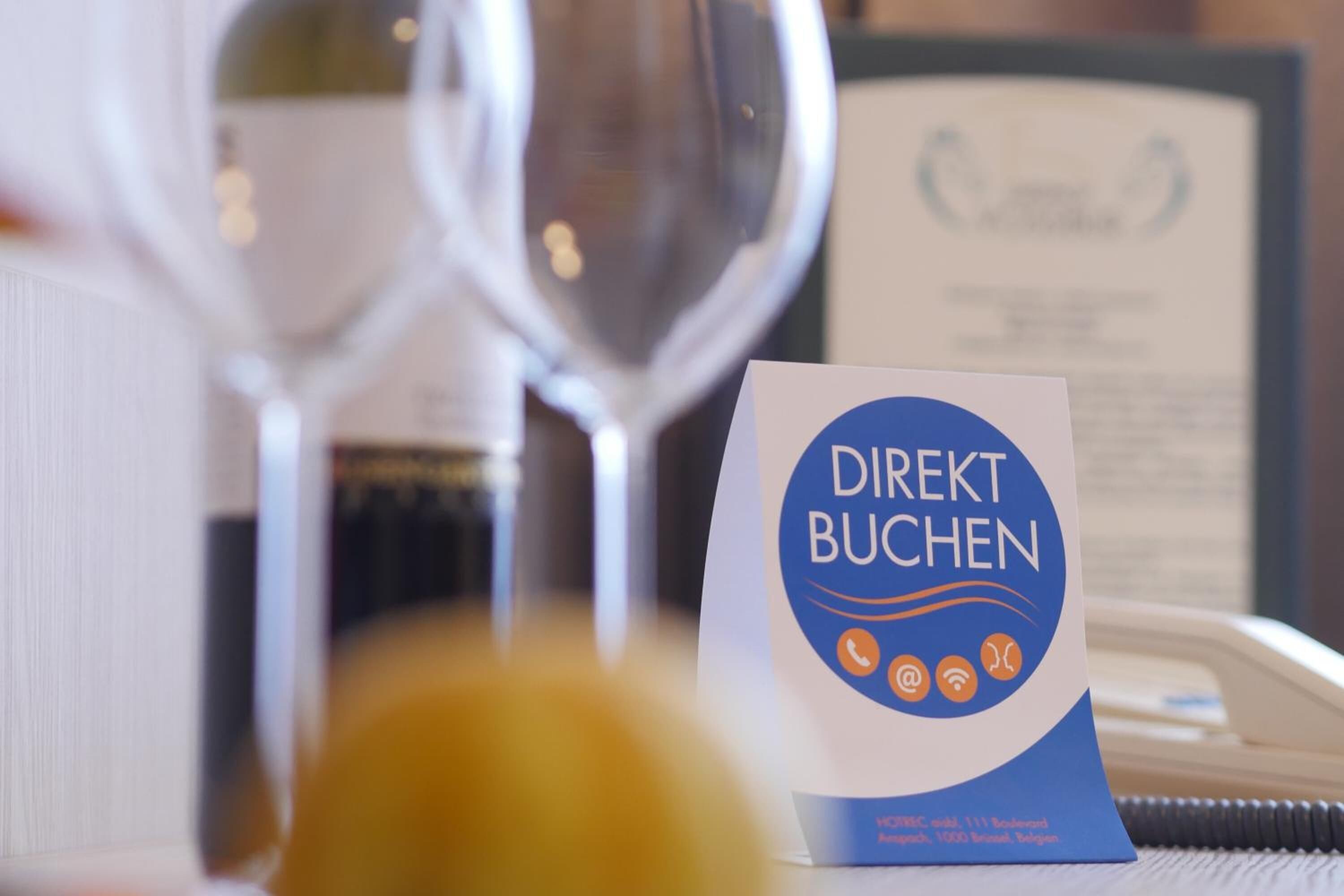 A business card for Direkt Buchen with a phone, email, and Wi-Fi icon.
