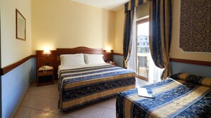 A hotel room with a large bed, a smaller bed, a bedside table, a nightstand, and a window with curtains. - Hotel Ristorante La Piana (Amorosi)