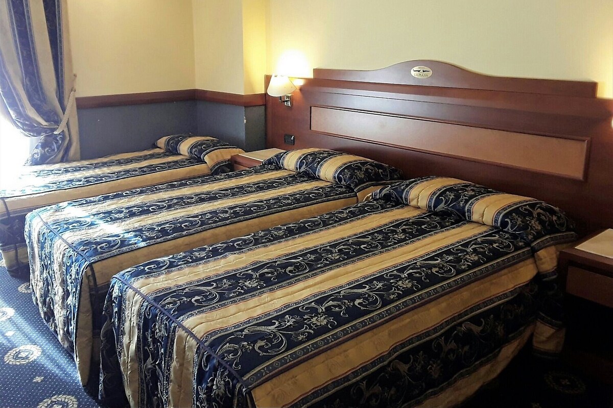 Premium bedding, desk, laptop workspace, blackout drapes