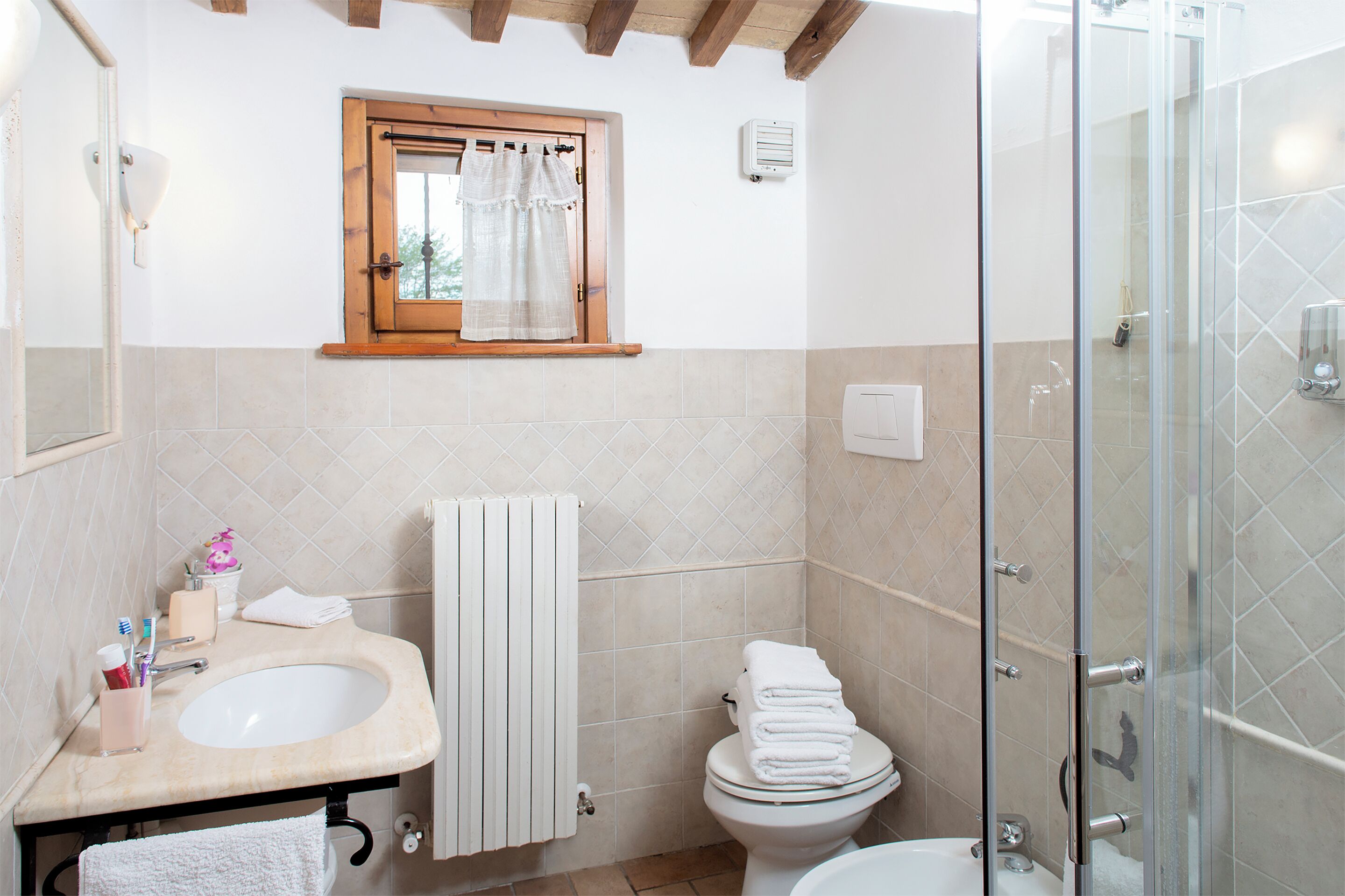 A bathroom with a sink, toilet, and shower.