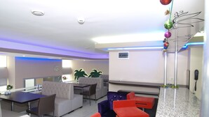 A modern hotel lobby with a seating area, a reception desk, and a decorative plant. - Timya Hotel (Istanbul)