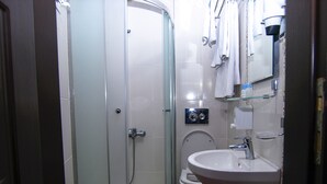 A bathroom with a glass-enclosed shower, a toilet, and a sink. - Timya Hotel (Istanbul)