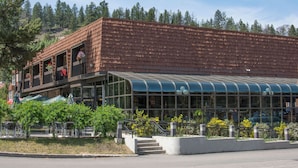 A building with a modern architectural design, featuring a glass facade and a wooden exterior.