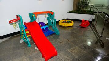 Kids can play and climb in this lively play area featuring a slide, climbing structure, and ball pit.