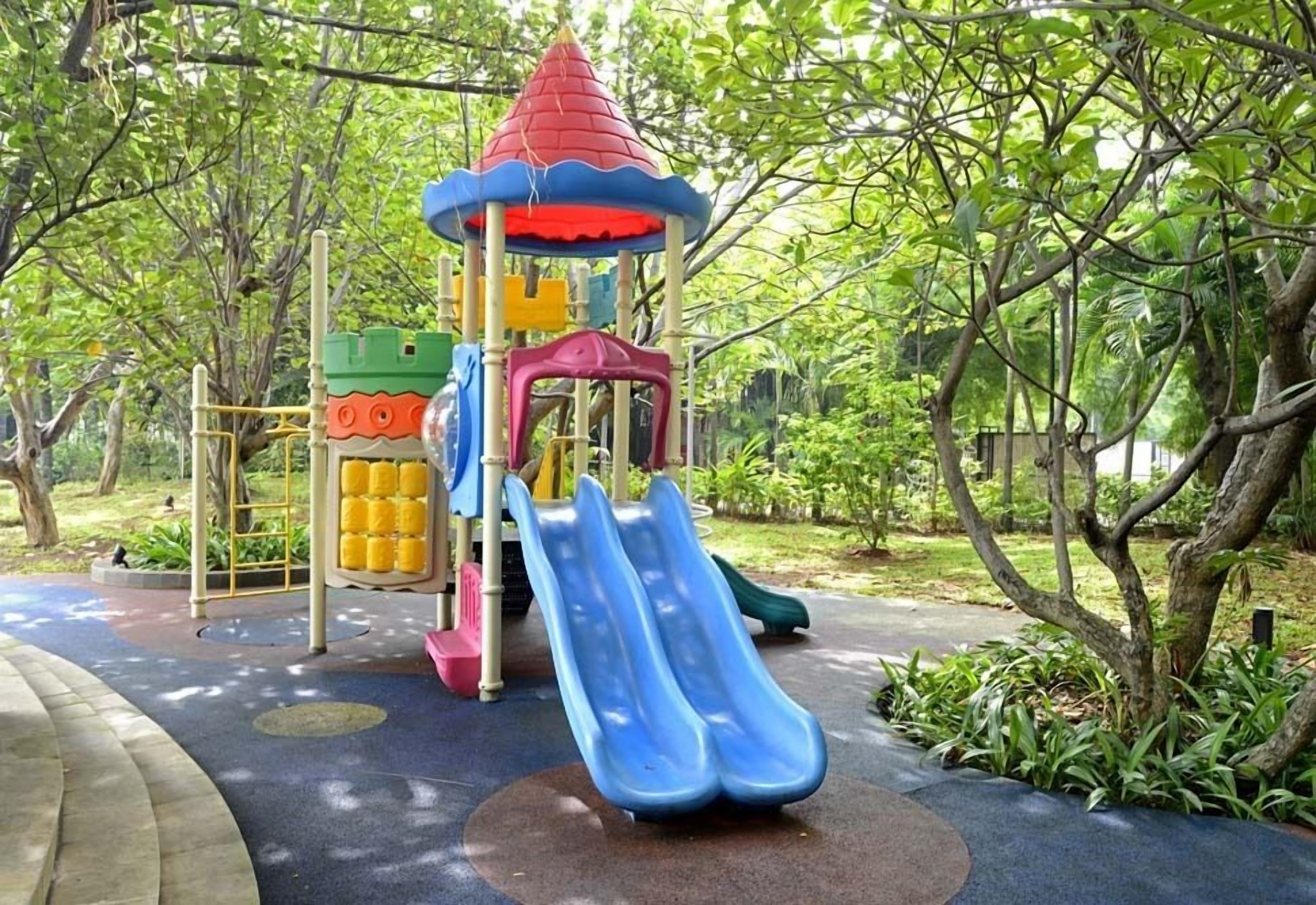 A playground with a slide, climbing structures, and a small pavilion.