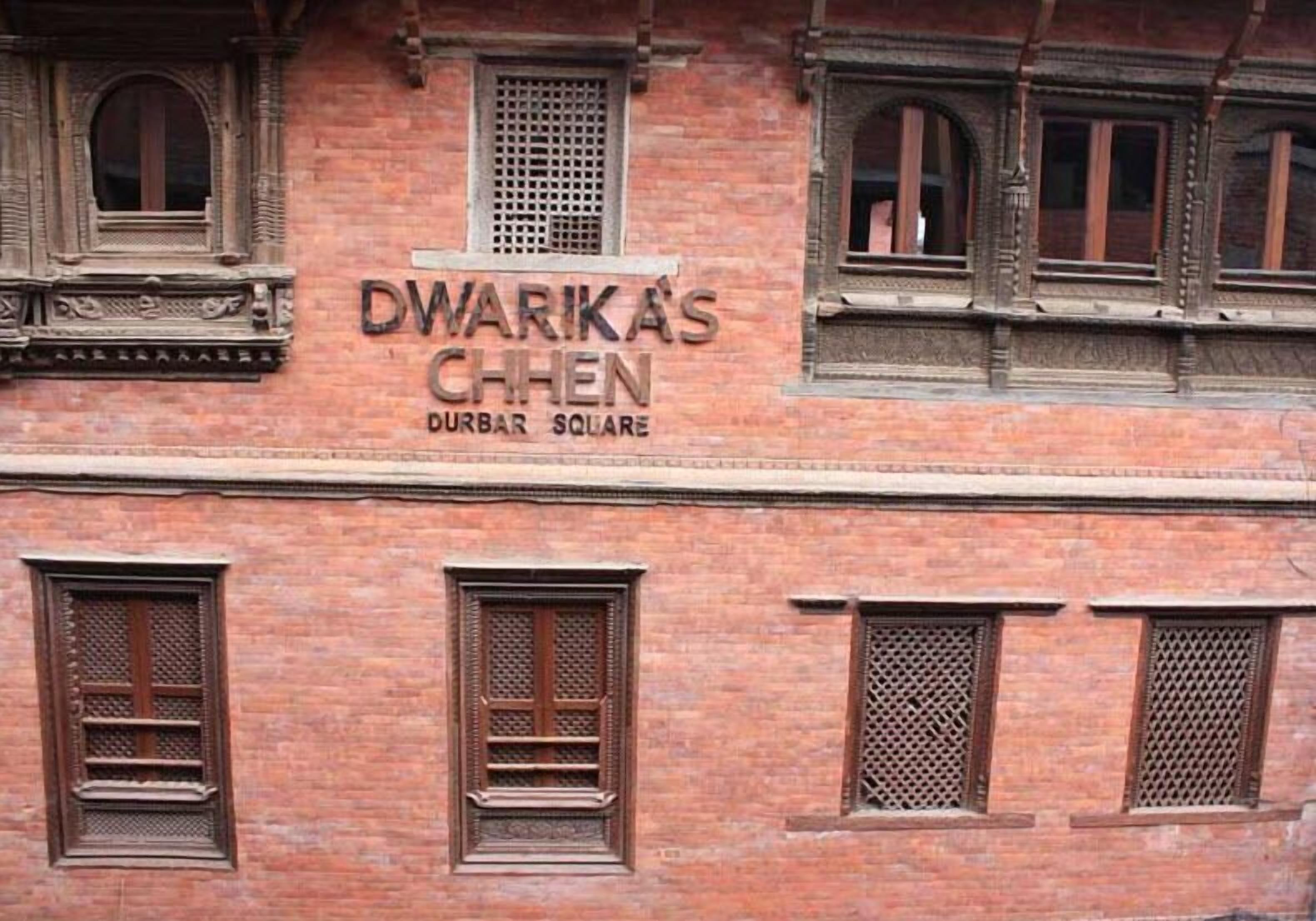 A building with a sign that reads "DWARKA'S CHEN DURBAR SQUARE".