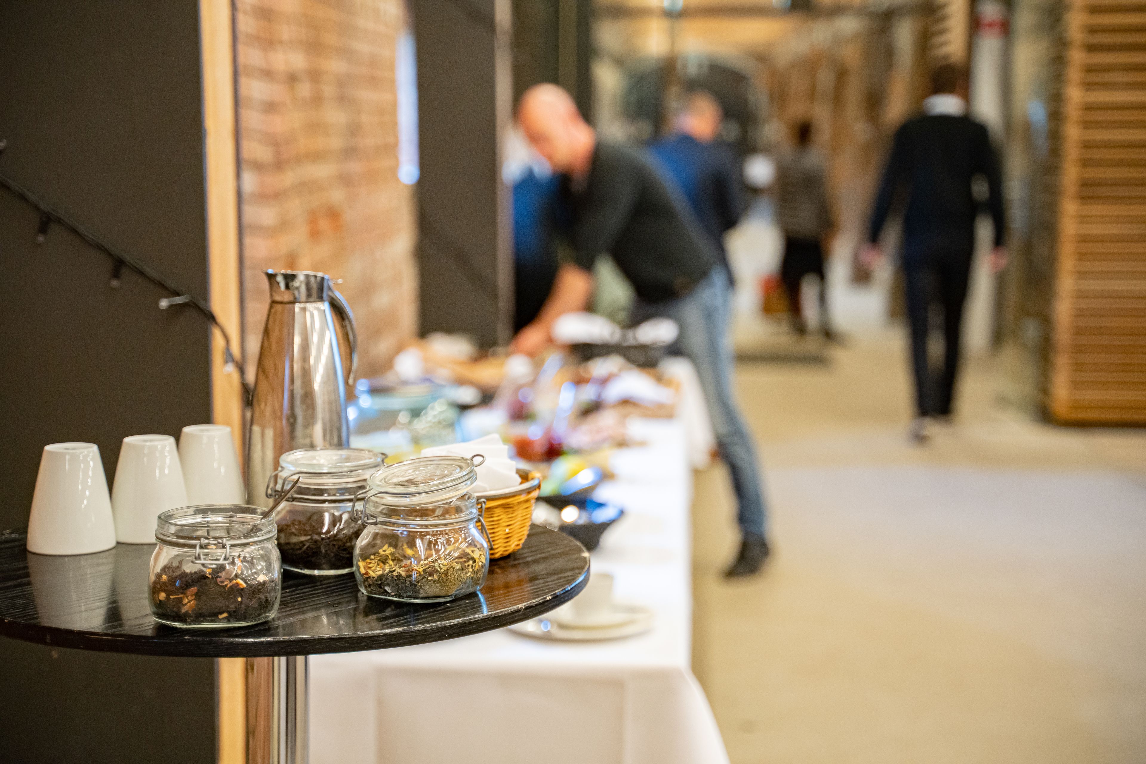 A buffet setup with various food items and condiments on a table.