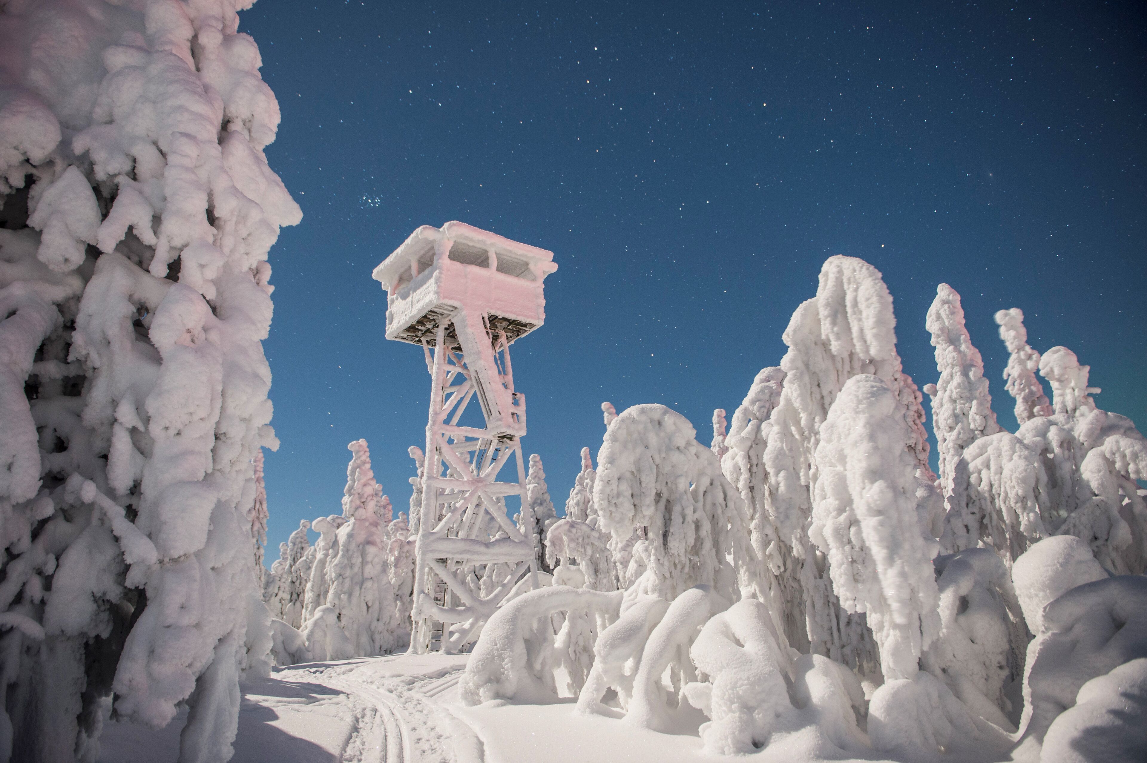 A snow-covered landscape with a tall observation tower.