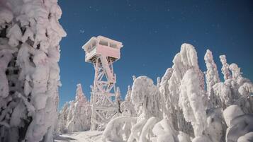 A snow-covered landscape with a tall observation tower.