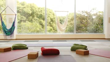 A yoga room with mats, blocks, and a hammock.