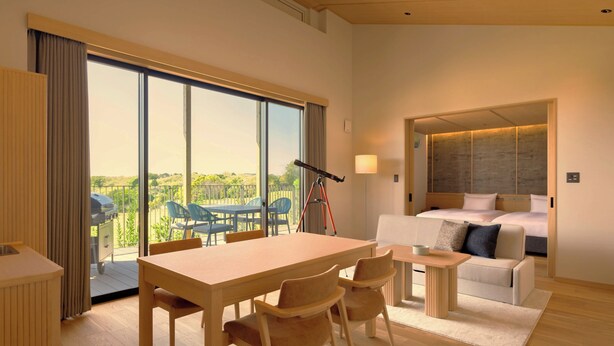 A modern hotel room with a large window, a dining area, a sofa, and a bed. - Nemu Resort Hotel Nemu (Shima)