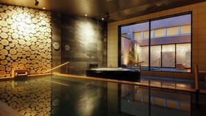 A modern indoor pool with a wooden log wall, a hot tub, and a view of a building through a large window. - Nemu Resort Hotel Nemu (Shima)