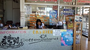 A tourist information counter with signs for tourist information, ticket, and free information. - Coffee Island - Hostel (Koh Samui)