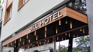 The exterior of the Jill Hotel with a modern facade, large glass windows, and a prominent entrance with a black awning. - Jill Hotel Brussels (Brussels)