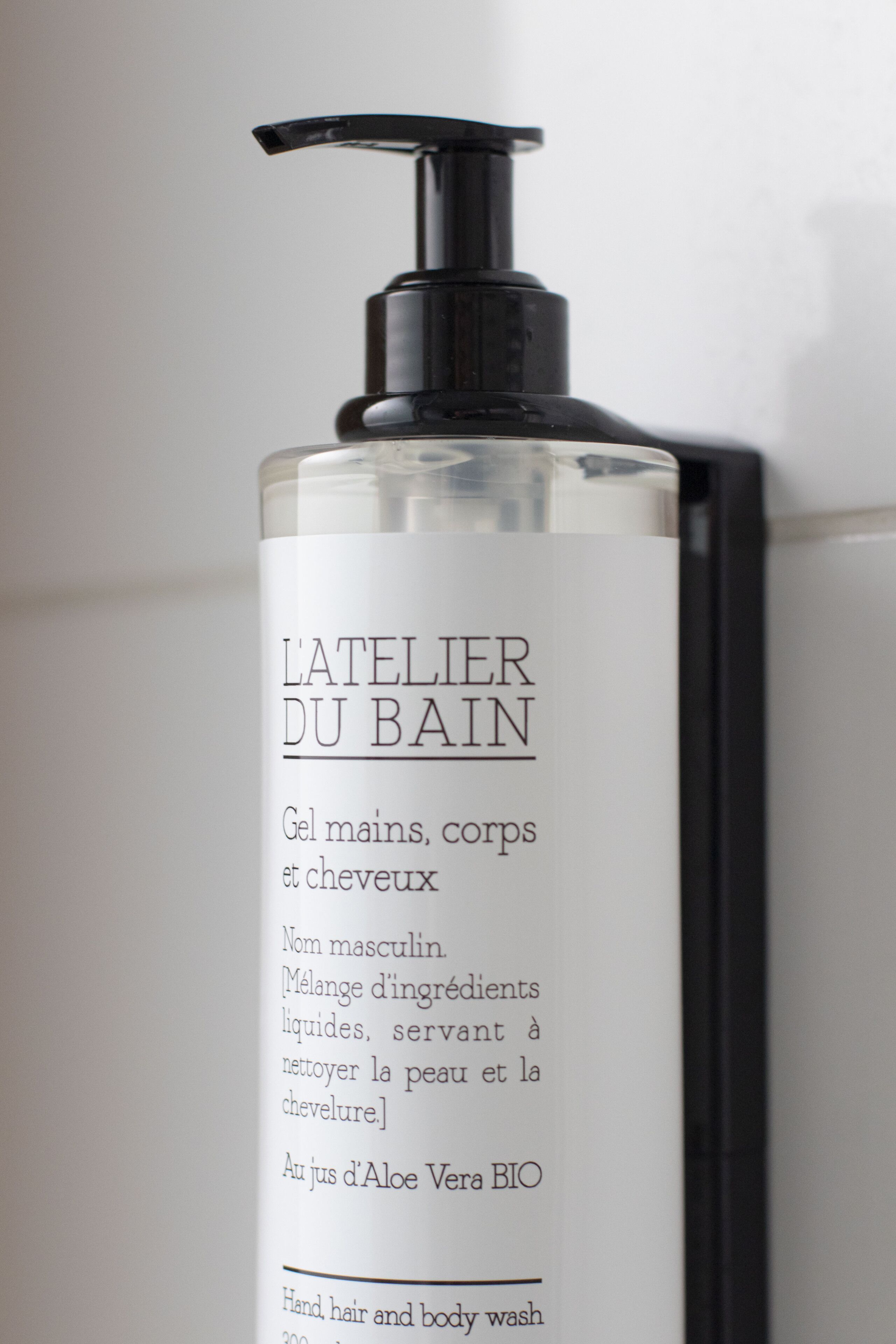 A bottle of L'Atelier Du Bain body wash.