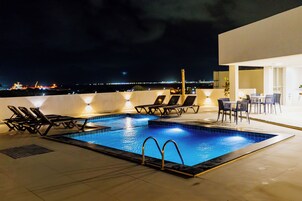 Piscina externa, guarda-sóis, espreguiçadeiras