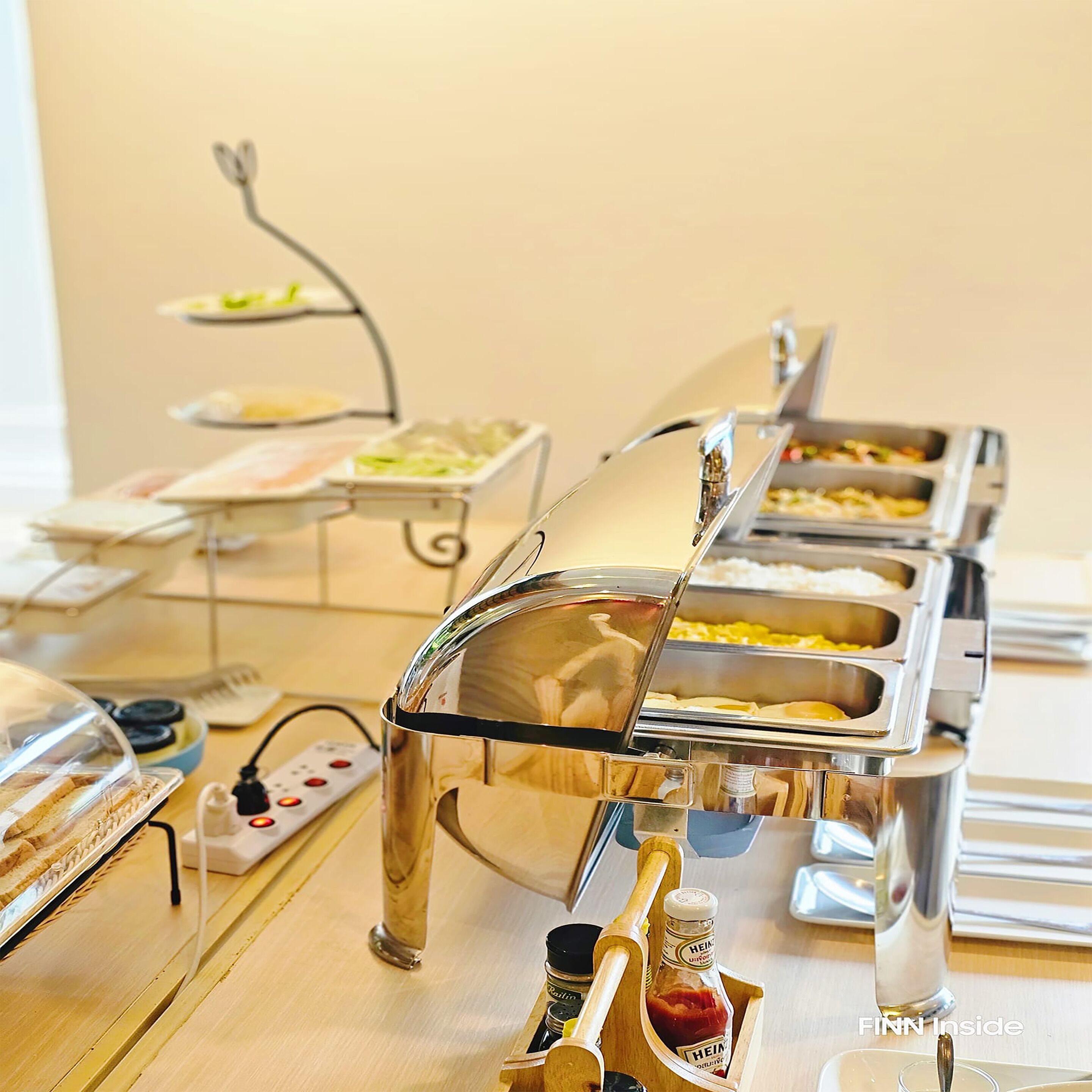 A buffet setup with various food stations and condiments.