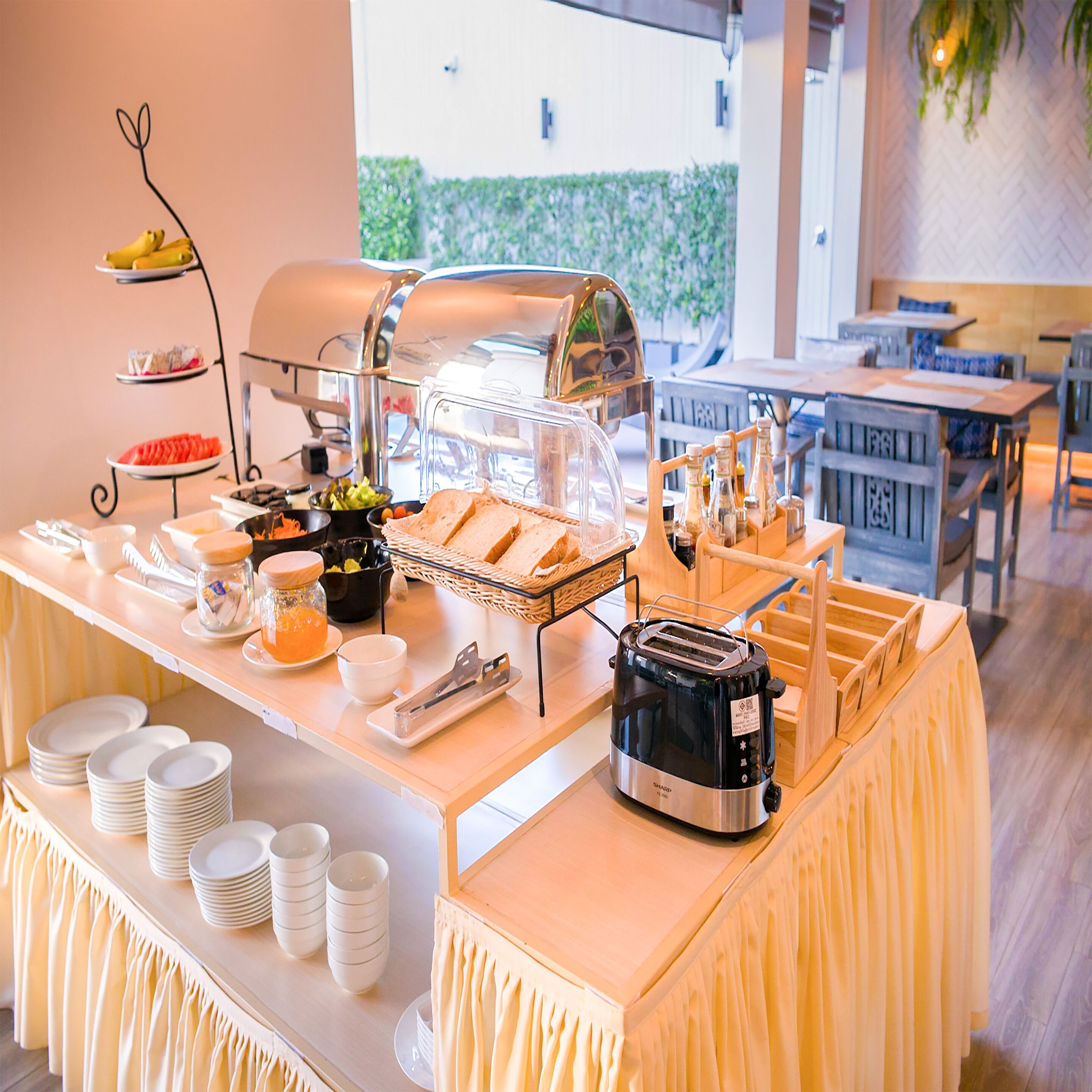A buffet setup with a grill, various food items, and a toaster.
