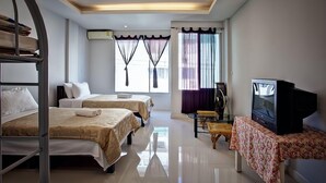 A hotel room with two beds, a television, and a fan. - Misone Hotel (Chiang Mai)