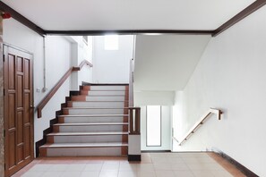 Eine Treppe mit Holzboden und Geländer, die zu einer oberen Etage führt.