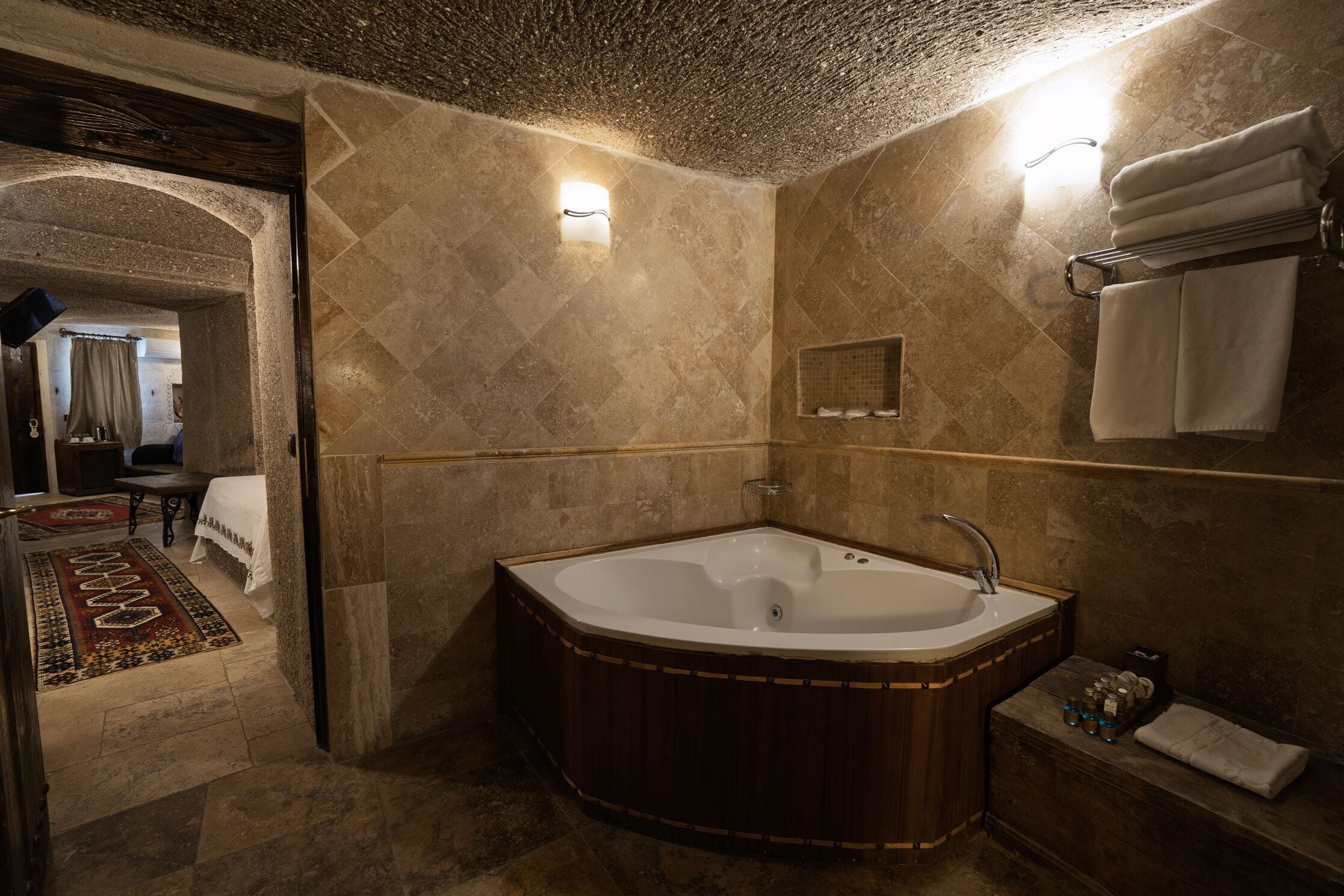 A bathroom with a freestanding bathtub, a towel rack, and a mirror.