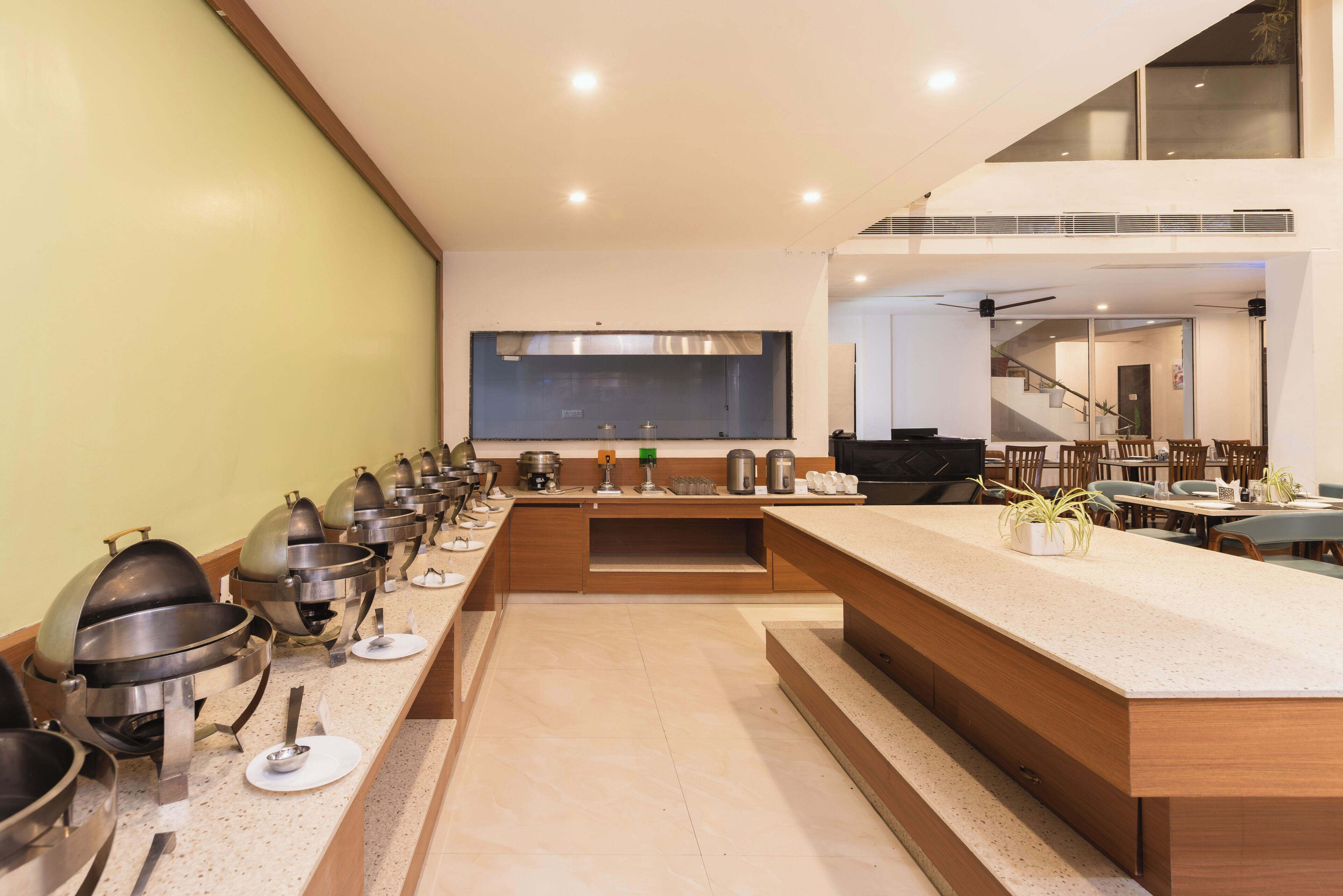 A modern kitchen with a long counter, multiple cooking stations, and a large island.