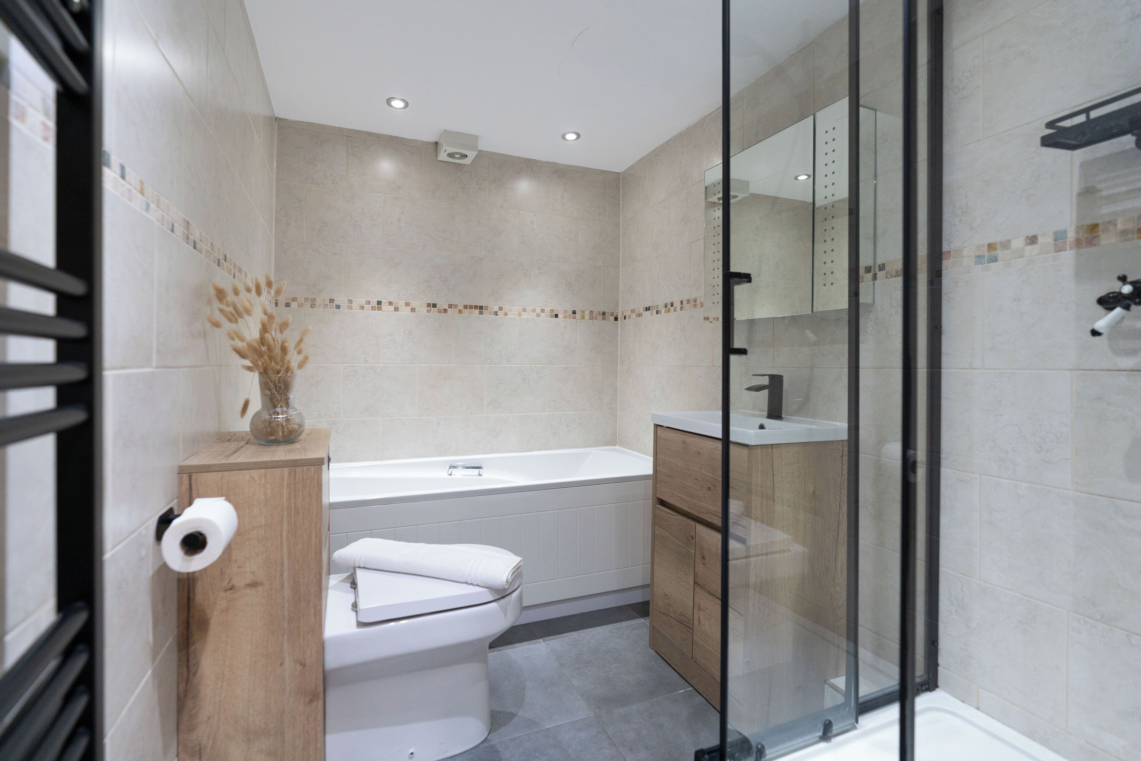 A modern bathroom with a toilet, sink, and bathtub.