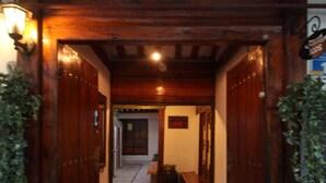 A wooden entrance with a tiled floor leading to a hallway. - iCOS Guesthouse 1 for Female - Hostel (Seoul)