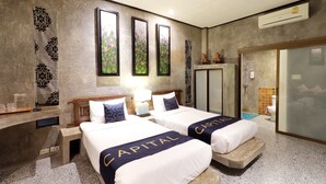 A hotel room with two beds, a vanity with a mirror, and artwork on the walls. - Capital O 464 At Nata Chiangmai Chic Jungle (Mae Rim)