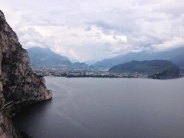 A coastal town with a prominent cliff and a calm sea.