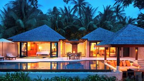 Un complexe hôtelier comprenant deux villas, chacune dotée d’un balcon, d’une piscine et offrant une vue sur les palmiers.