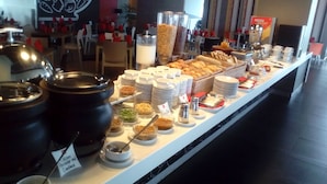 A buffet with various food items and condiments. - ibis Surabaya City Center (Surabaya)