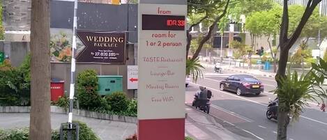 A hotel sign with "ibis" branding, indicating a hotel named "ibis" with a room for 1 or 2 people.