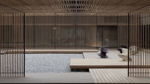 Un interior moderno con una terraza de madera, una zona de estar con sillas contemporáneas y un amplio ventanal.