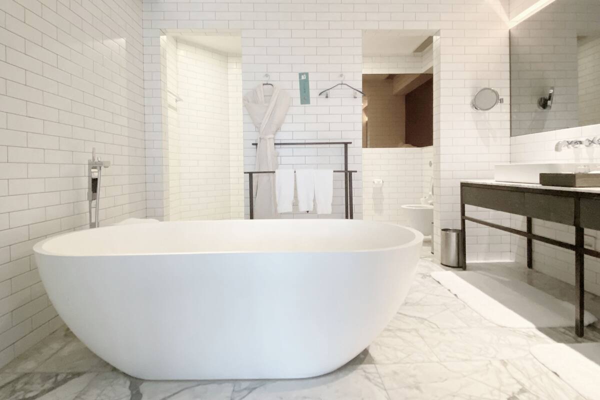 suite, 1 king bed, city view | bathroom | separate bathtub and shower, hair dryer, towels