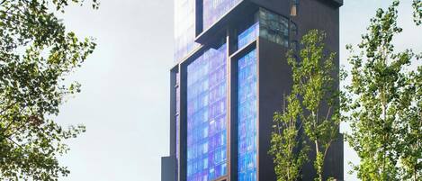 A modern building with multiple glass windows and a structured design.