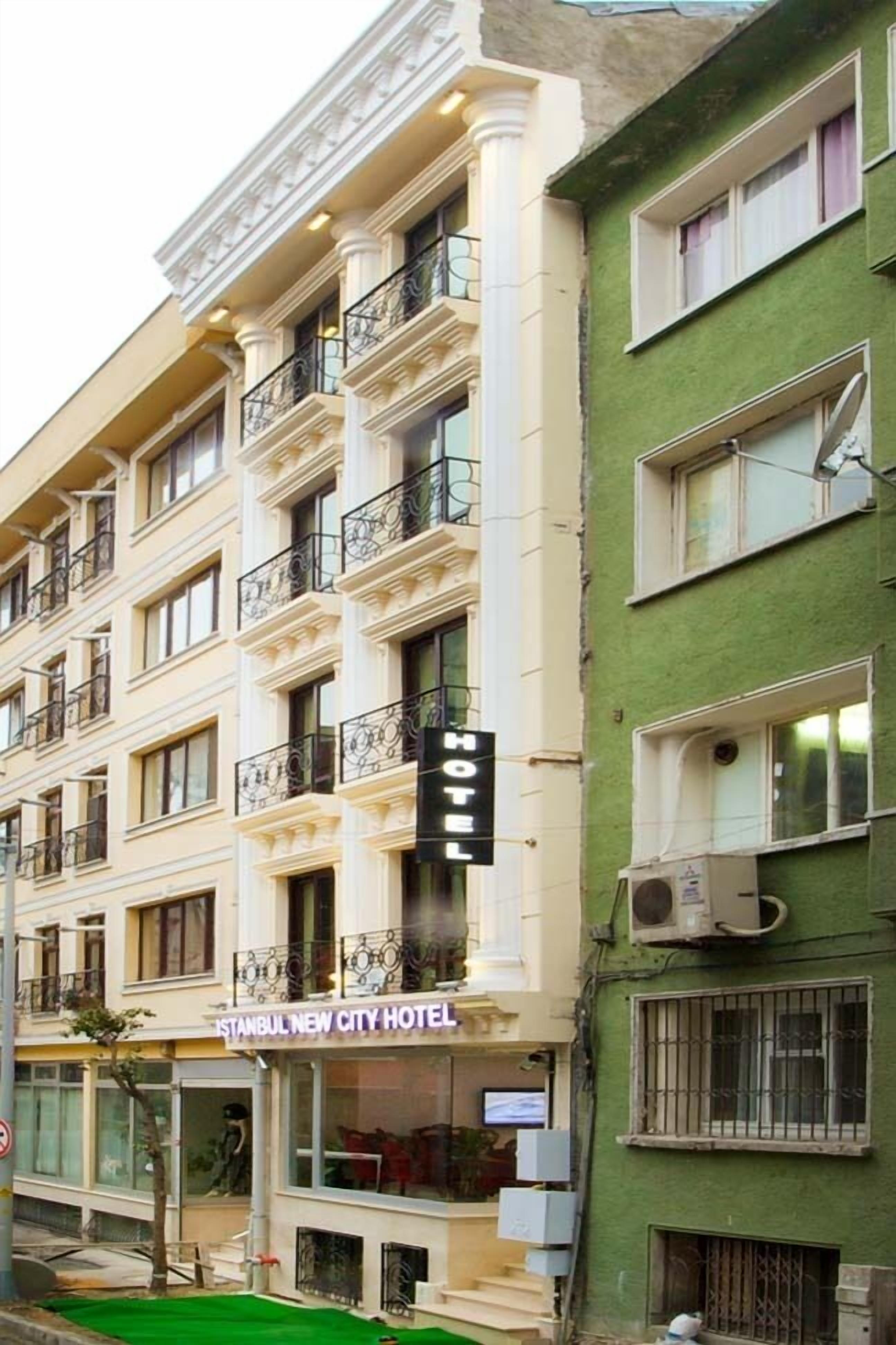 A multi-story building with a sign reading "ISTANBUL NEW CITY HOTEL."