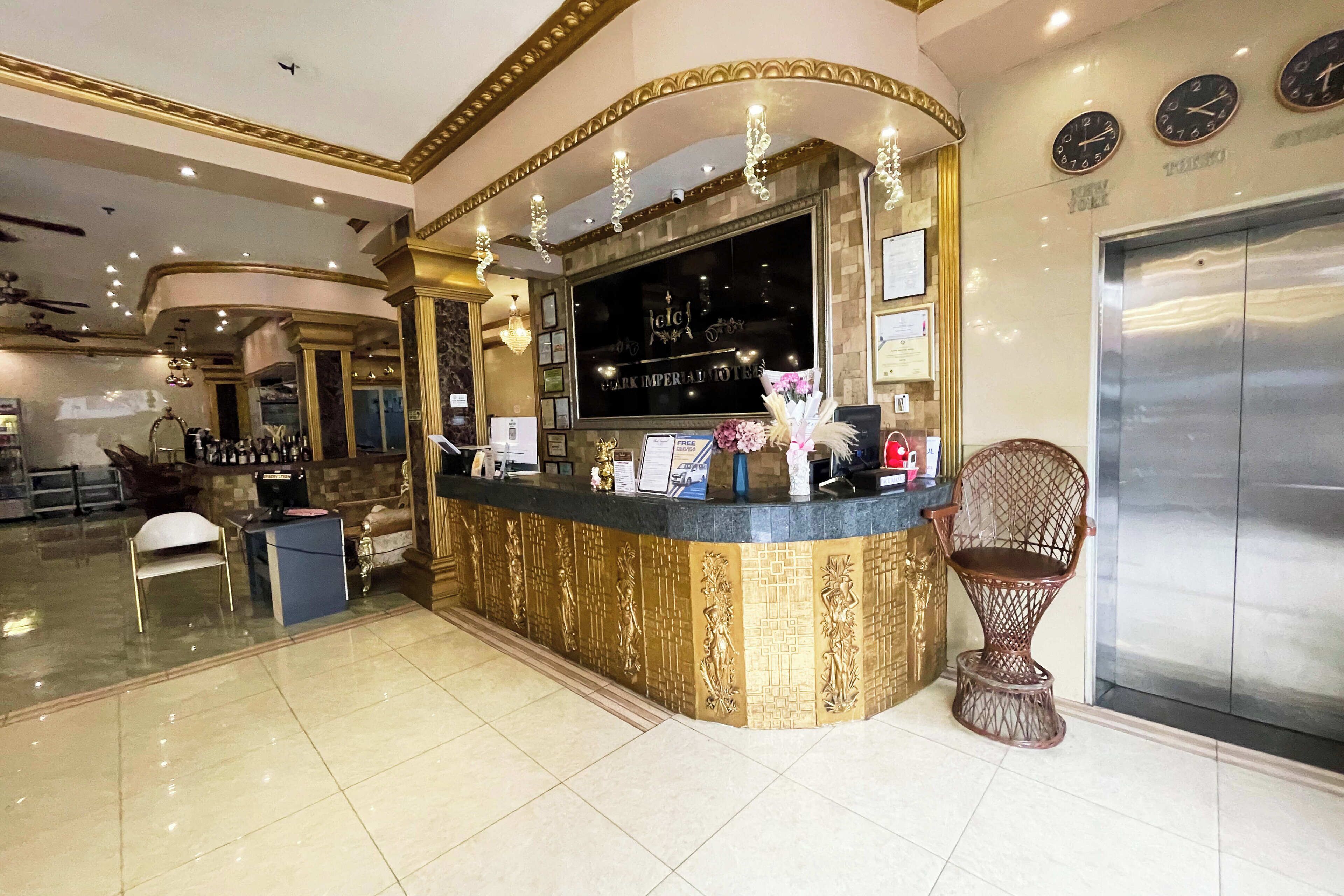 A reception area with a counter, a large screen, and an elevator.