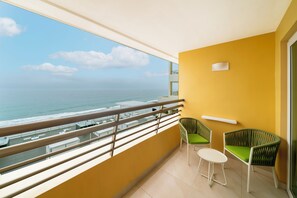 A balcony with a view of the ocean, two wicker chairs, and a small table. - Iberostar Selection Playa Mita - All Inclusive (Punta de Mita)