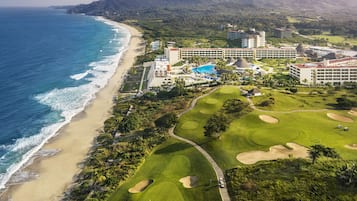 Enjoy stunning ocean views from our beachfront villas, featuring a golf course, pool, spa, dining options, and fitness center.