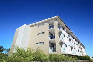 A multi-story building with balconies, large windows, and a flat roof. - Oaks Moranbah Suites (Moranbah)