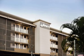 A modern building with a prominent sign reading "CAKS". - Oaks Moranbah Suites (Moranbah)