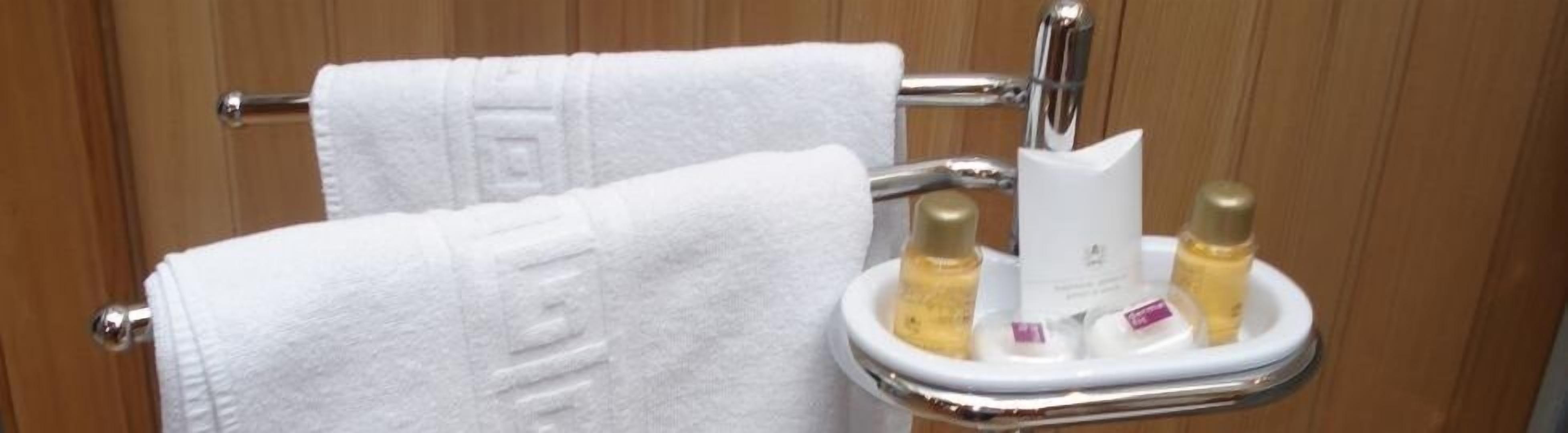 bathtub, hair dryer, bathrobes, towels