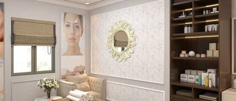 Un cuarto de spa con una camilla de masaje, un tocador con artículos de aseo y un espejo decorativo.